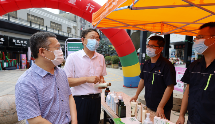 图为在化妆品“零假货”集中交易市场启动仪式上，义务监督员现场宣传化妆品法规文件。